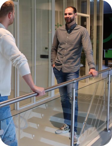 Foto van Thom te Riet in gesprek met een collega over AI en zijn specialisme.